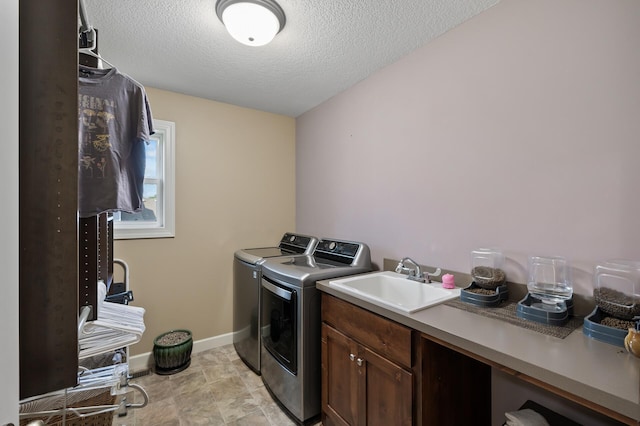 10412 Florida Ave N, Brooklyn Park, MN 55445 - laundry area featuring separate washer and dryer, a textured ceiling, and cabinet space