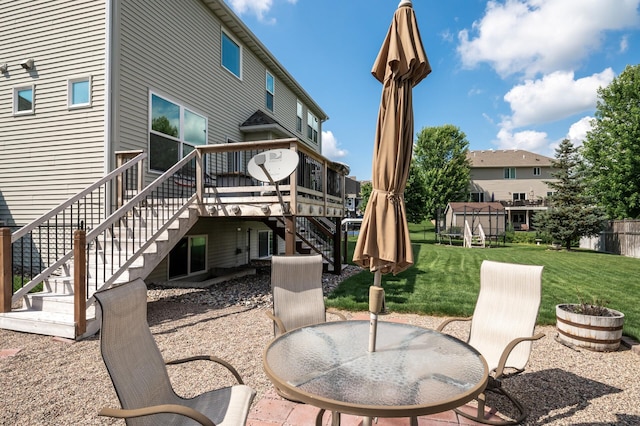 10412 Florida Ave N, Brooklyn Park, MN 55445 - back of house featuring stairway, a wooden deck, a patio area, and a lawn
