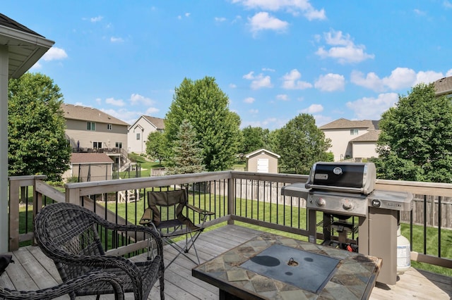 10412 Florida Ave N, Brooklyn Park, MN 55445 - wooden terrace with a residential view, a yard, a storage shed, and grilling area