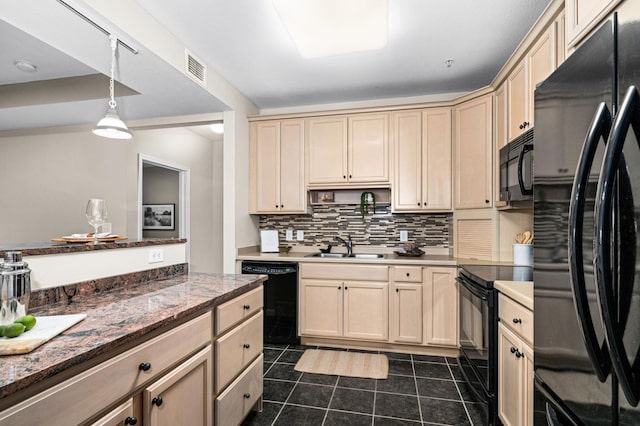 1126 Mesaba Ave Unit 118, Duluth, MN 55811 - kitchen with black appliances, tasteful backsplash, dark tile patterned flooring, hanging light fixtures, and cream cabinets