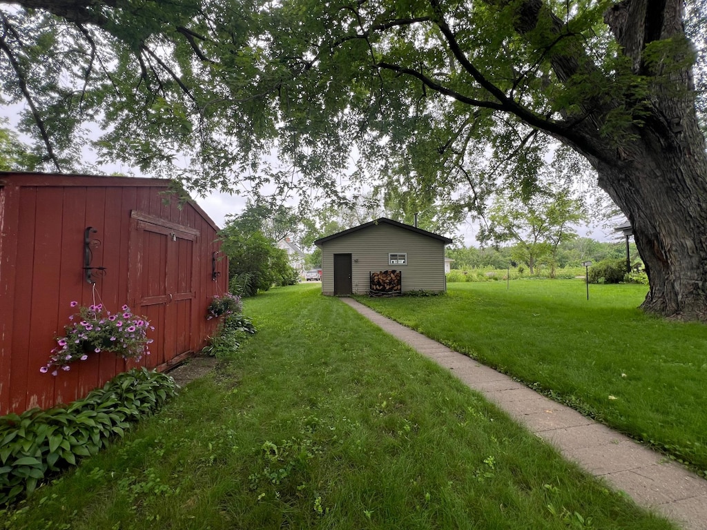 416 Wallace St N, Delano, MN 55328 - view of green lawn with a storage unit