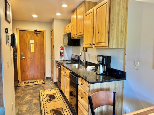 140 Bridge Run Ln Unit C, Lutsen Twp, MN 55615 - kitchen featuring black appliances, dark stone countertops, recessed lighting, and dark stone finish floors