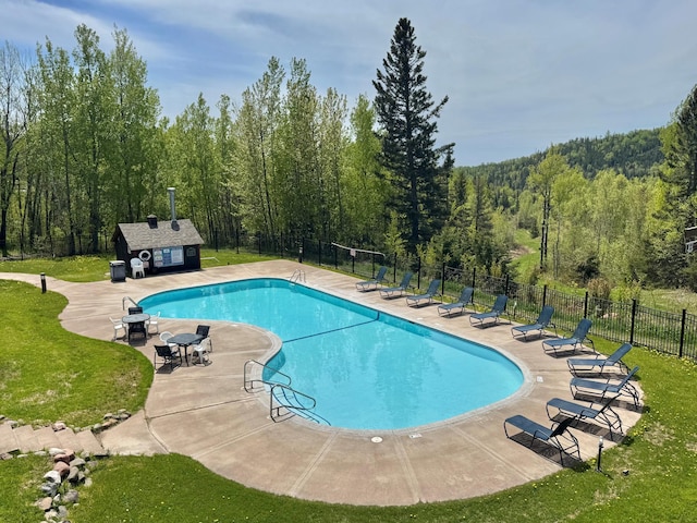 140 Bridge Run Ln Unit C, Lutsen Twp, MN 55615 - community pool featuring a patio area and a wooded view