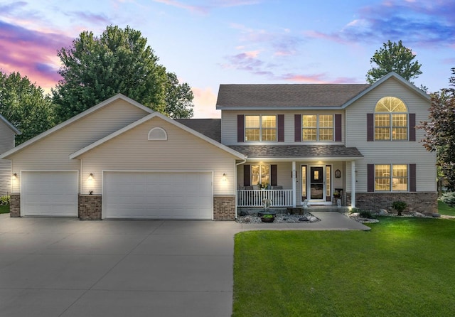 1405 17th Dr SW, Austin, MN 55912 - view of front of property featuring covered porch, brick siding, a garage, concrete driveway, and a lawn