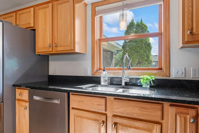 1405 17th Dr SW, Austin, MN 55912 - kitchen featuring appliances with stainless steel finishes, decorative light fixtures, and dark stone counters