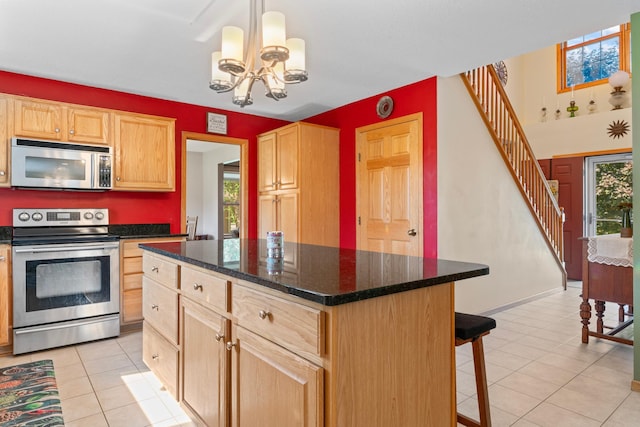 1405 17th Dr SW, Austin, MN 55912 - kitchen with stainless steel appliances, light brown cabinetry, light tile patterned flooring, and plenty of natural light