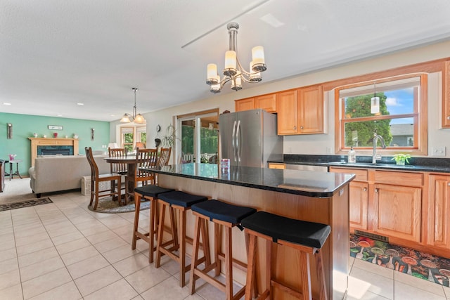 1405 17th Dr SW, Austin, MN 55912 - kitchen with appliances with stainless steel finishes, dark countertops, light tile patterned floors, a chandelier, and healthy amount of natural light