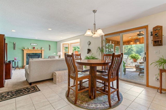 1405 17th Dr SW, Austin, MN 55912 - dining space featuring light tile patterned floors, a premium fireplace, recessed lighting, and a chandelier