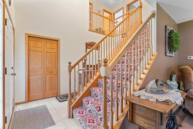 1405 17th Dr SW, Austin, MN 55912 - entryway featuring stairway, tile patterned floors, and a high ceiling
