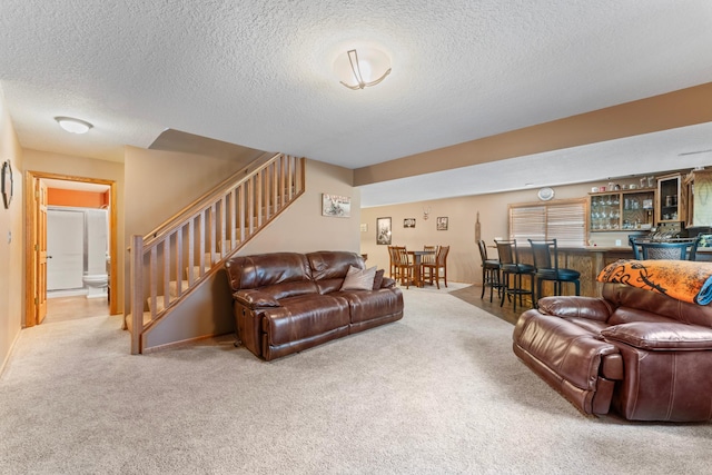 1405 17th Dr SW, Austin, MN 55912 - living room featuring wet bar, carpet floors, stairs, and a textured ceiling