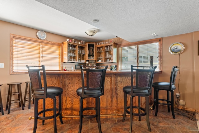 1405 17th Dr SW, Austin, MN 55912 - indoor wet bar with stone finish floors and a textured ceiling