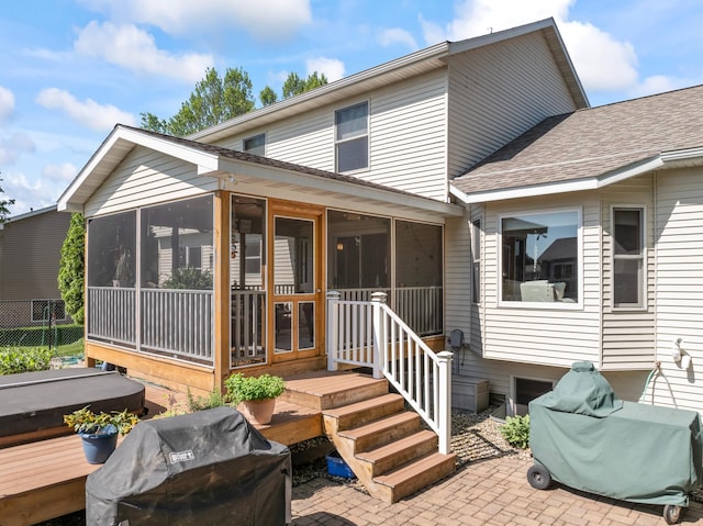 1405 17th Dr SW, Austin, MN 55912 - rear view of property with a sunroom, roof with shingles, and a patio