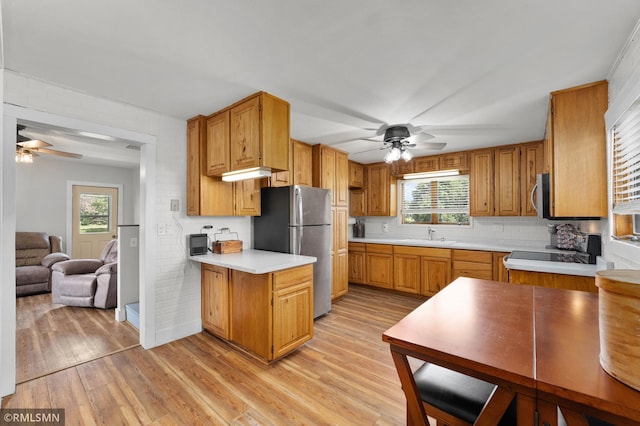 W10429 Hinker Rd, Foster Twp, WI 54493 - kitchen featuring stainless steel appliances, ceiling fan, light countertops, and light wood finished floors