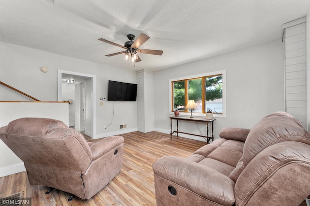 W10429 Hinker Rd, Foster Twp, WI 54493 - living area featuring a ceiling fan, light wood finished floors, and a textured ceiling