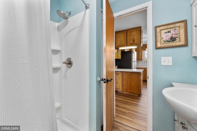 W10429 Hinker Rd, Foster Twp, WI 54493 - bathroom featuring a shower with curtain and wood finished floors