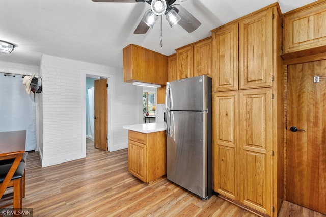 W10429 Hinker Rd, Foster Twp, WI 54493 - kitchen with freestanding refrigerator, a ceiling fan, light countertops, and light wood-style floors