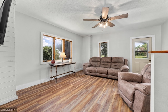 W10429 Hinker Rd, Foster Twp, WI 54493 - living room with ceiling fan, light wood-style floors, and a textured ceiling