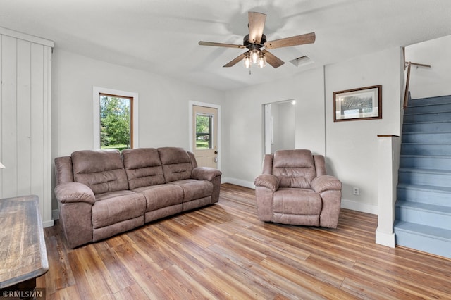 W10429 Hinker Rd, Foster Twp, WI 54493 - living area featuring ceiling fan, light wood-style flooring, and stairway