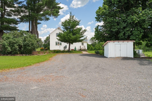 W10429 Hinker Rd, Foster Twp, WI 54493 - view of front of house with a storage shed and driveway