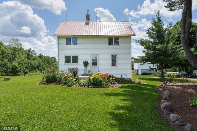 W10429 Hinker Rd, Foster Twp, WI 54493 - rear view of property featuring a lawn, a chimney, and a metal roof