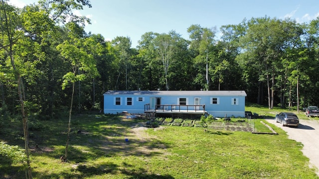 31700 Cherry Lake Rd, Ogema, MN 56569 - manufactured / mobile home with a deck, a front lawn, and a wooded view