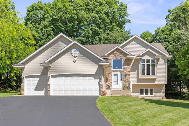 911 Hazelwood Ct, Buffalo, MN 55313 - view of front of house featuring stone siding, driveway, a garage, a front yard, and roof with shingles