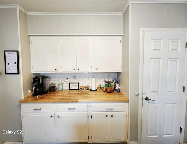 1033 Mark St, Winona, MN 55987 - kitchen with white cabinetry, ornamental molding, wooden counters, and tasteful backsplash