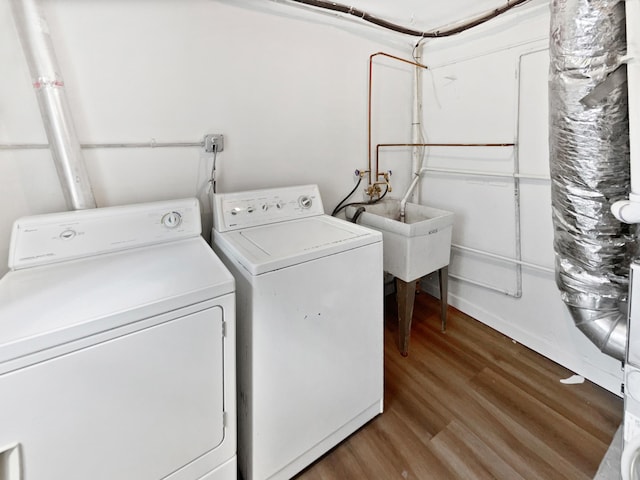 6043 17th St N, Oakdale, MN 55128 - laundry room featuring washer and clothes dryer and wood finished floors