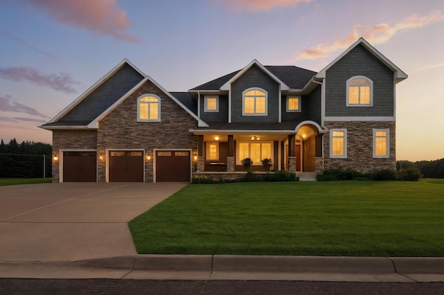 1570 Wood Duck Ln NE, Owatonna, MN 55060 - craftsman-style home featuring covered porch, stone siding, a front lawn, concrete driveway, and an attached garage