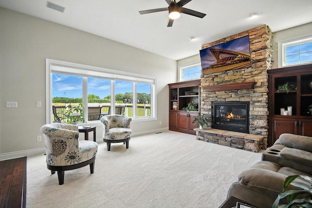 1570 Wood Duck Ln NE, Owatonna, MN 55060 - living area with ceiling fan and a stone fireplace