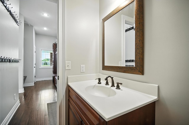 1570 Wood Duck Ln NE, Owatonna, MN 55060 - bathroom with vanity, wood finished floors, and recessed lighting