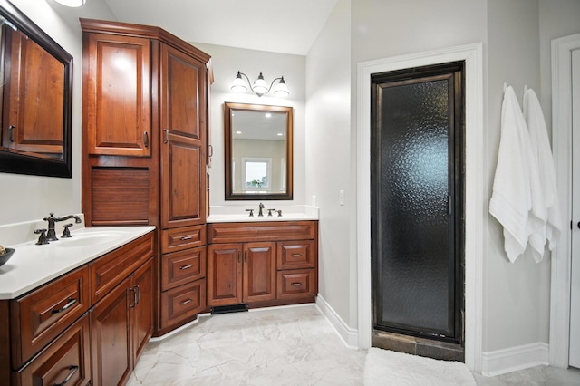 1570 Wood Duck Ln NE, Owatonna, MN 55060 - bathroom featuring double vanity, a shower stall, and marble finish flooring