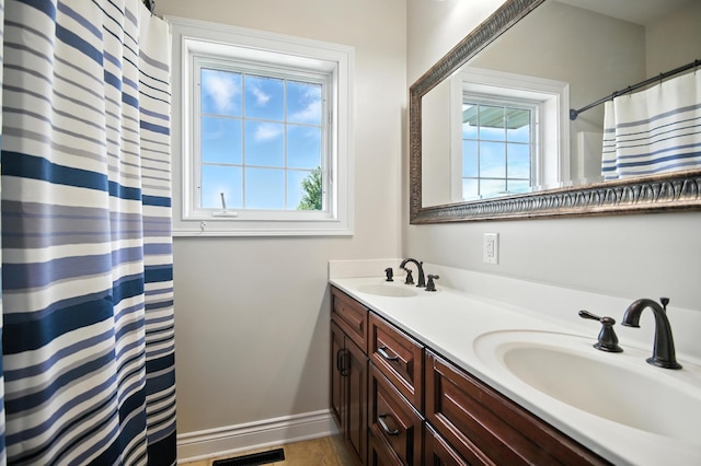 1570 Wood Duck Ln NE, Owatonna, MN 55060 - bathroom with double vanity and curtained shower