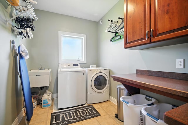 1570 Wood Duck Ln NE, Owatonna, MN 55060 - washroom with cabinet space, washing machine and clothes dryer, and light tile patterned flooring