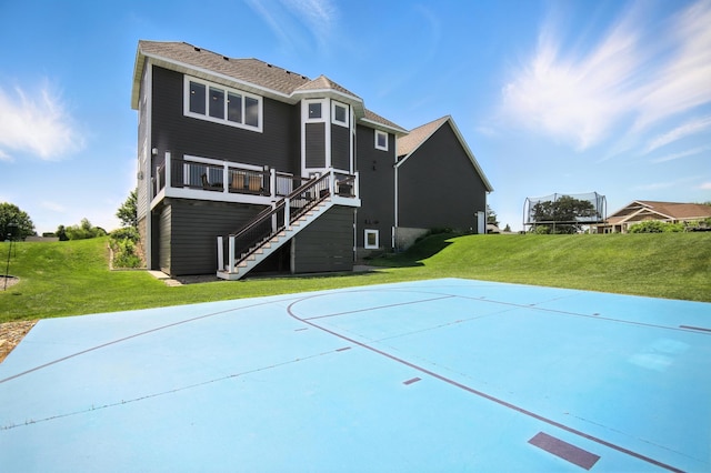 1570 Wood Duck Ln NE, Owatonna, MN 55060 - rear view of property with a yard, basketball court, stairs, and a wooden deck