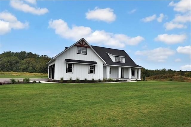 7591 255th St, Wyoming, MN 55092 - modern inspired farmhouse with covered porch, a front yard, and board and batten siding