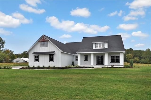 7591 255th St, Wyoming, MN 55092 - modern inspired farmhouse with a front yard, covered porch, and board and batten siding