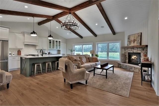 7591 255th St, Wyoming, MN 55092 - living room with a chandelier, beam ceiling, light wood-style flooring, a fireplace, and recessed lighting