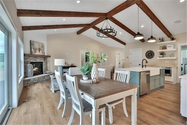 7591 255th St, Wyoming, MN 55092 - dining room with light wood-style flooring, a stone fireplace, a chandelier, and recessed lighting
