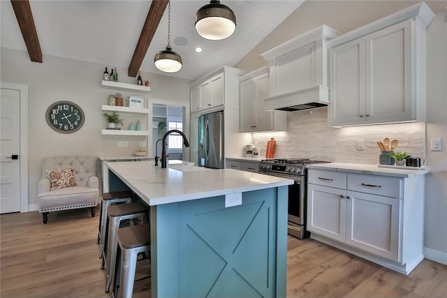 7591 255th St, Wyoming, MN 55092 - kitchen with appliances with stainless steel finishes, open shelves, backsplash, a breakfast bar area, and light wood-style flooring