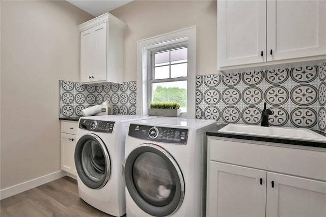 7591 255th St, Wyoming, MN 55092 - laundry room with washer and clothes dryer, cabinet space, and wood finished floors