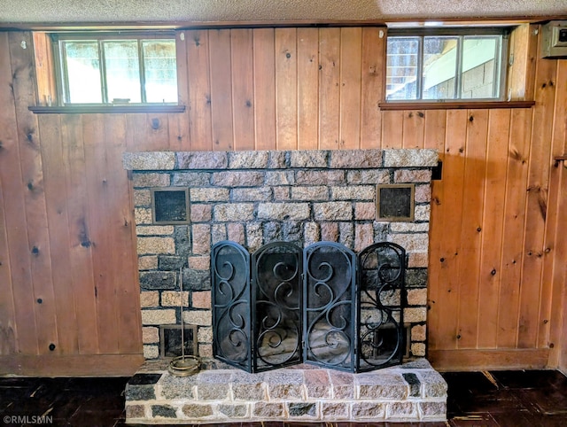 711 Main St N, Browerville, MN 56438 - detailed view of a fireplace with raised hearth, wood walls, and a textured ceiling