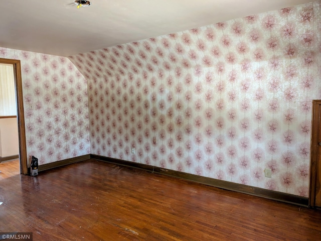 711 Main St N, Browerville, MN 56438 - spare room featuring wood-type flooring and wallpapered walls