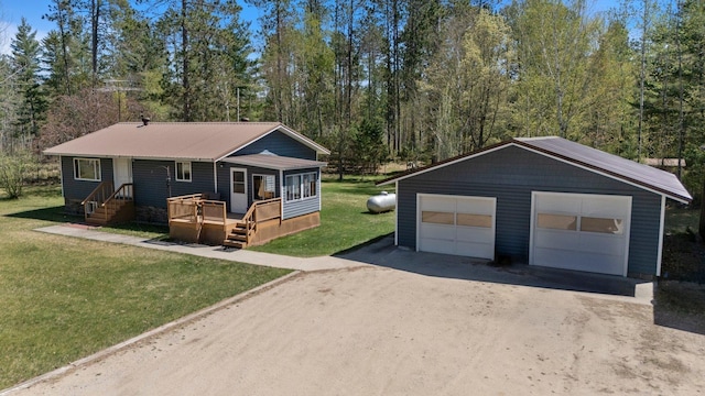 24621 Long Lake Rd, Bigfork, MN 56628 - view of front of property with an outdoor structure, a detached garage, a front yard, and a metal roof