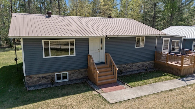 24621 Long Lake Rd, Bigfork, MN 56628 - view of front of house with a metal roof and a front lawn