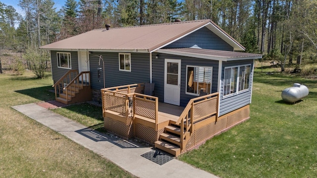 24621 Long Lake Rd, Bigfork, MN 56628 - back of property featuring a lawn, a deck, and a metal roof