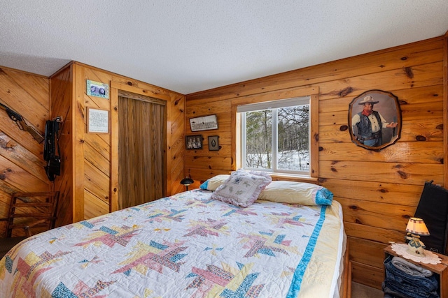 24621 Long Lake Rd, Bigfork, MN 56628 - bedroom featuring a textured ceiling and wood walls