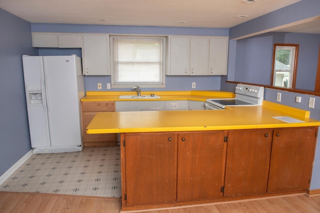 304 Pearl St, Spring Valley, MN 55975 - kitchen with white appliances, a peninsula, light countertops, light flooring, and plenty of natural light