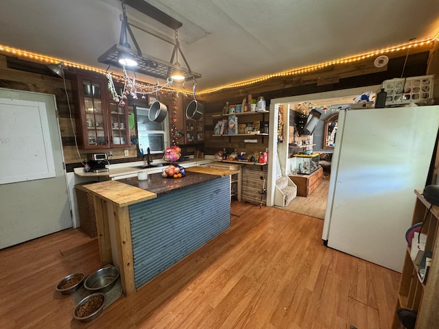 117 Maple Ave, Frazee, MN 56544 - kitchen with freestanding refrigerator, wooden counters, open shelves, a kitchen island, and glass insert cabinets
