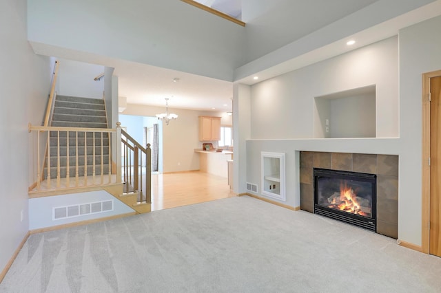 9633 Belmont Ln, Eden Prairie, MN 55347 - unfurnished living room with carpet floors, stairway, a fireplace, a chandelier, and recessed lighting